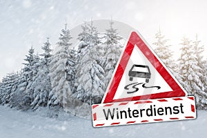 Warning sign German word Winterdienst winter services with car for ice smoothness at the winter season photo