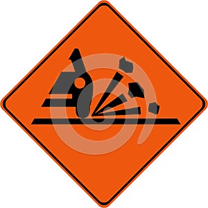 Warning sign with gravel on road