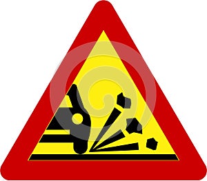 Warning sign with gravel on road