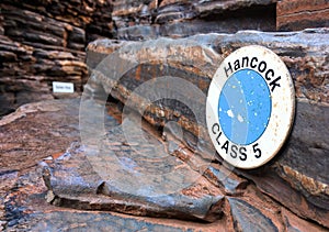 The warning sign in Hancock Gorge in Karijini National Park in Pilbara region, Western Australia showing the difficulty