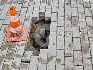 Warning sign and a hole on the sidewalk