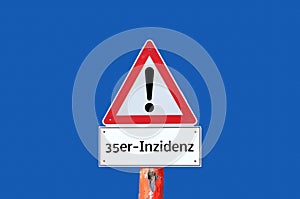 Warning sign 35 incidence value on blue background in geman photo