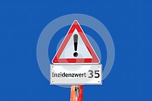Warning sign incidence value 35 on blue background in german photo