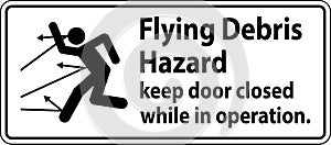 Warning sign indicating the risk of flying debris, advising to keep the door closed