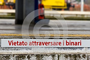 Warning sign in italian Vietato attraversare i binari in Mestre train station, Venice photo