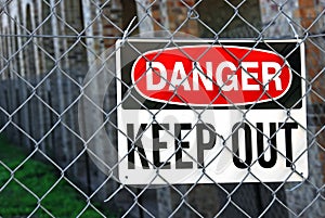 Warning sign on metal fence