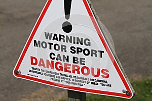 Warning sign for motor racing.