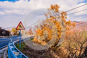 Warning sign next to guardrail