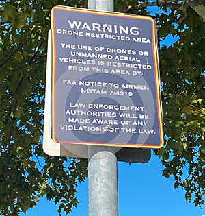 Warning Sign Posted on Metal Pole drone restricted area