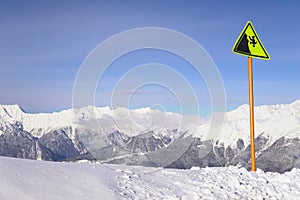 Warning sign on the precipice of the ski resort snow winter