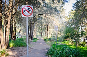 Warning sign at the public park walkway for Bicycles Prohibited.