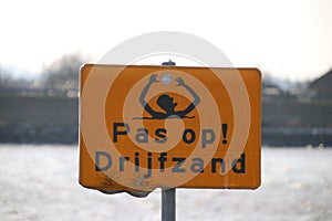warning sign for quicksand at the Hollandse IJssel riverside