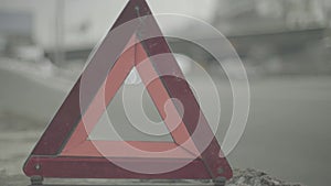 Warning sign `Red Triangle` on the road. Close-up. Crash. Car breakdown