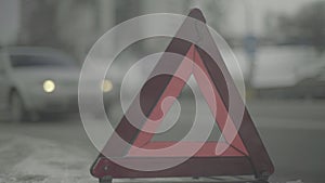 Warning sign `Red Triangle` on the road. Close-up. Crash. Car breakdown