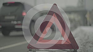 Warning sign `Red Triangle` on the road. Close-up. Crash. Car breakdown