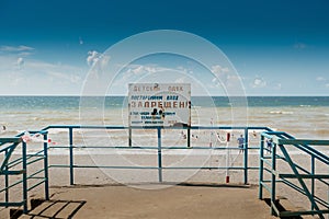 Warning sign on the shore. Text in Russian:Children& x27;s beach. Unauthorized entry is prohibited to the shore.