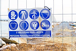 Warning sign on the shoreline in Follonica, Italy