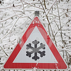 Warning sign shows danger of ice and snow at street