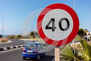 A warning sign in Spain. Tempo 40 allowed in front of a roundabout.