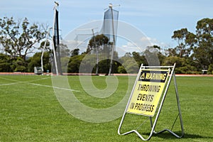 Warning sign for spectators and athletes that throwing events are taking place