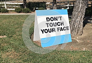 Warning sign stating donÃ¢â¬â¢t touch your face