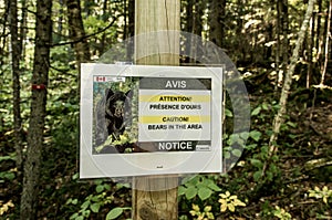 Warning sign telling hikers to be Bear Aware in La Mauricie National Park Quebec, Canada on a beautiful day