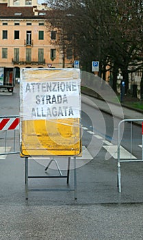 warning sign with text ATTENZIONE STRADA ALLAGATA in italian that means CAUTION FLOODED ROAD