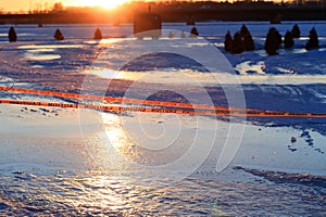 Warning sign of thin ice in the fishing village installed on lake