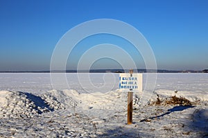 Warning sign of THIN ICE at lakeside