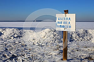 Warning sign of THIN ICE at lakeside