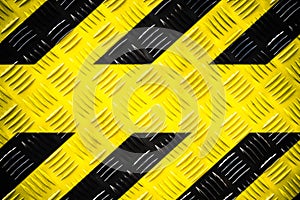 Warning sign with yellow and black stripes painted on steel checker plate or diamond plate hazard danger warning background