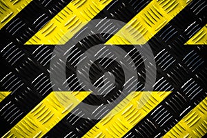 Warning sign yellow and black stripes painted on steel checker plate or diamond plate warning danger background