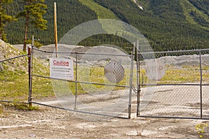 Warning signs on blocked entrance at decommissioned asbestos mine at Cassiar, BC, Canada photo