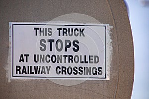 Warning signs on metal tank truck back