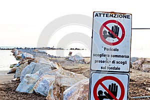 Warning signs on the shoreline in Follonica, Italy