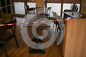 Warning tape blocks a cafe, which has to close during lockdown due to coronavirus pandemic