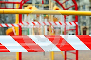 Warning tape close up on closed playground. Quarantine Covid-19