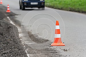 Warning traffic road cone stand on asphalt city road during roadworks