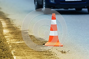 Warning traffic road cone stand on asphalt city road during roadworks