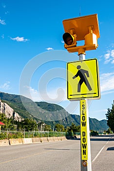 Warning Traffic Sign at a Crosswalk along a Street in a Mountain Town