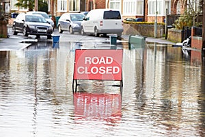 Warning Traffic Sign On Flooded Road