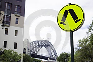 Warning traffic signs for pedestrian crossing in yellow circle.