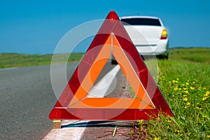 Warning triangle. Car breakdown on a country road. Malfunction of the car
