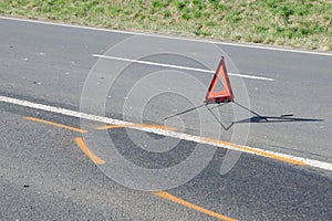 Warning triangle on the road after the car crash