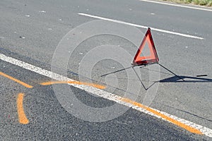 Warning triangle on the road after the car crash