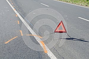 Warning triangle on the road after the car crash