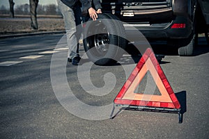 Warning triangle stands on the tarmac road