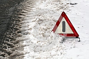 Warning triangle on winter road