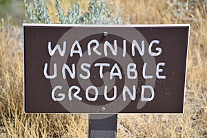 Warning Unstable ground sign at trail head.