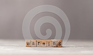 Warning word made of wooden stamps